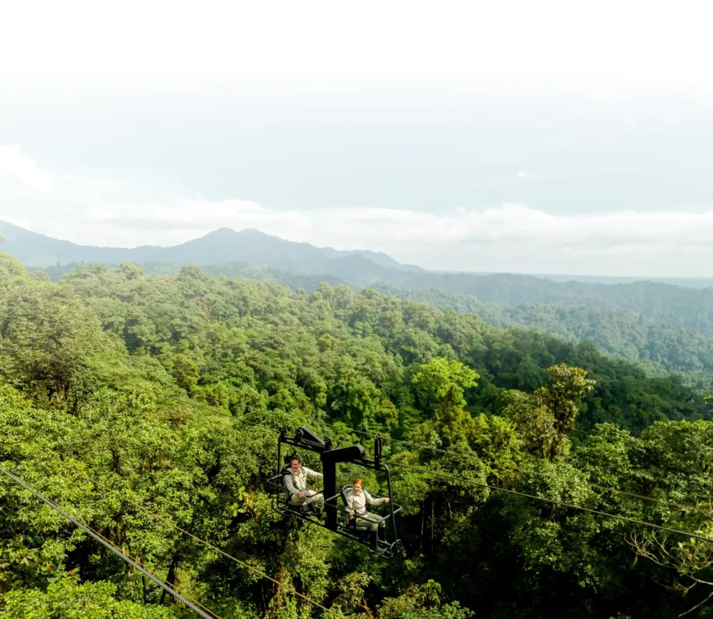 mashpi activities skybike panoramic Guests enjoy a skybike ride above the lush canopy at Mashpi Lodge, offering a unique panoramic view of the cloud forest.