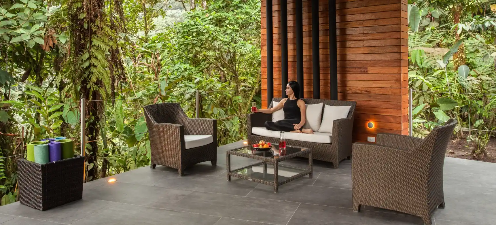 Woman in serene yoga pose on Mashpi Lodge's Samay Yoga Deck, enveloped by lush Ecuadorian cloud forest.