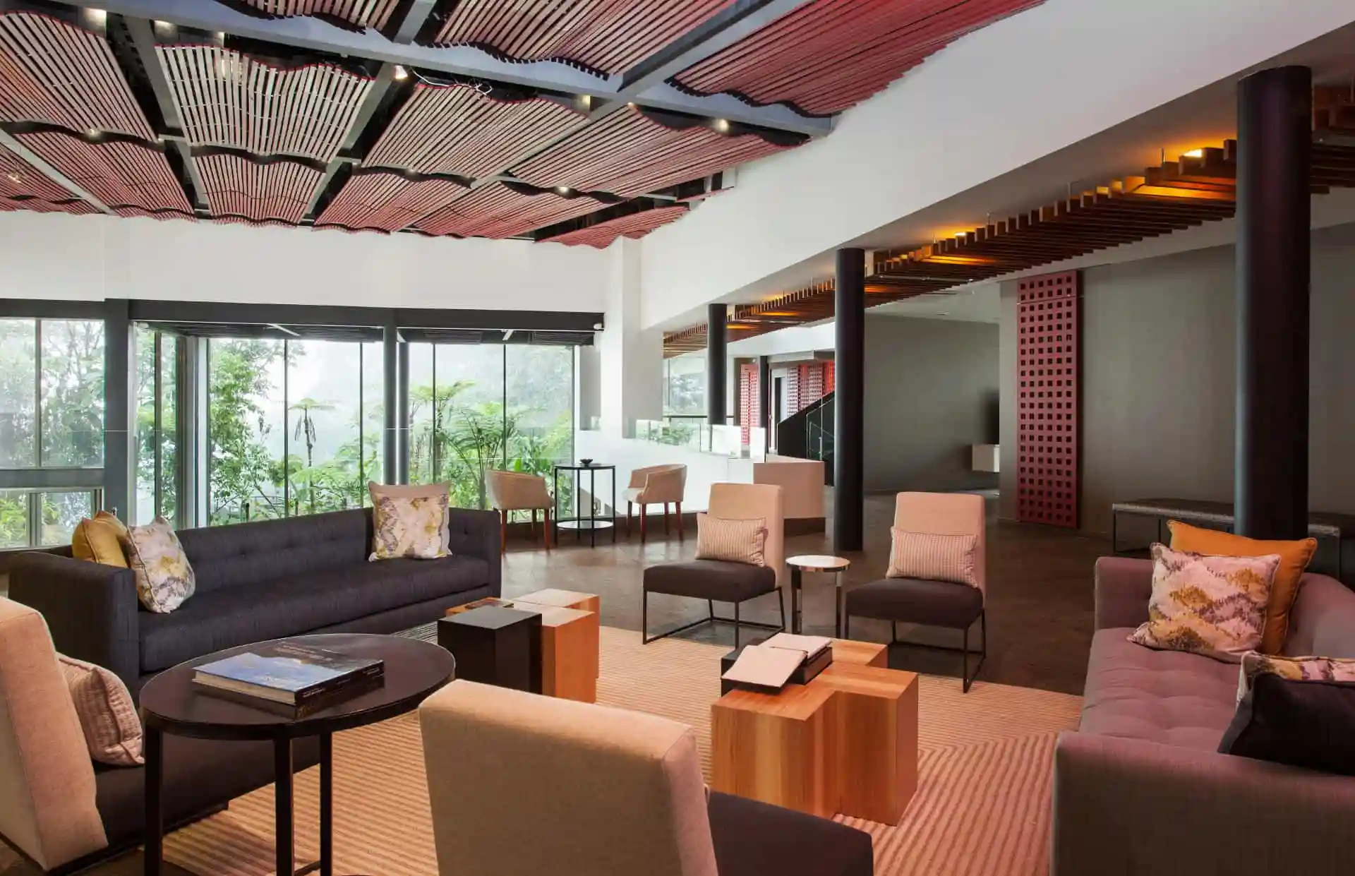 mashpi lodge lounge room view The lounge room at Mashpi Lodge elegantly combines modern comfort with panoramic views of the Ecuadorian cloud forest, creating a space for relaxation and reflection.
