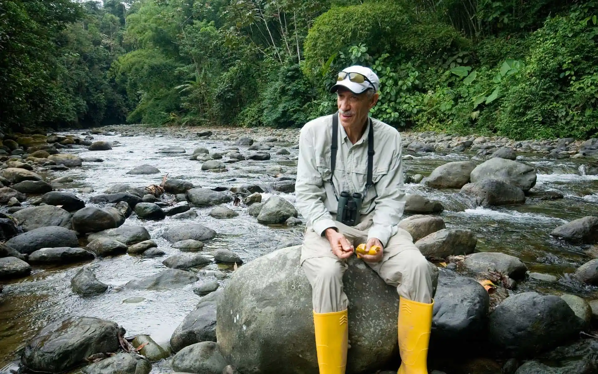 Roque Sevilla in natural setting at Mashpi Lodge during an interview, surrounded by a serene river landscape.