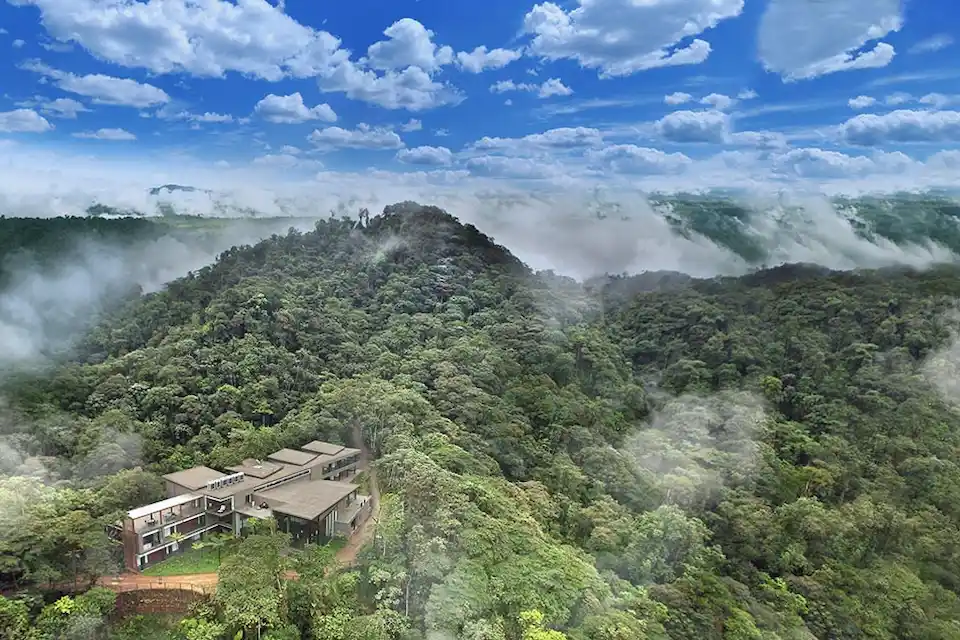 Sweeping view of Mashpi Lodge amidst the lush Ecuadorian cloud forest, capturing the essence of a serene mountain retreat.